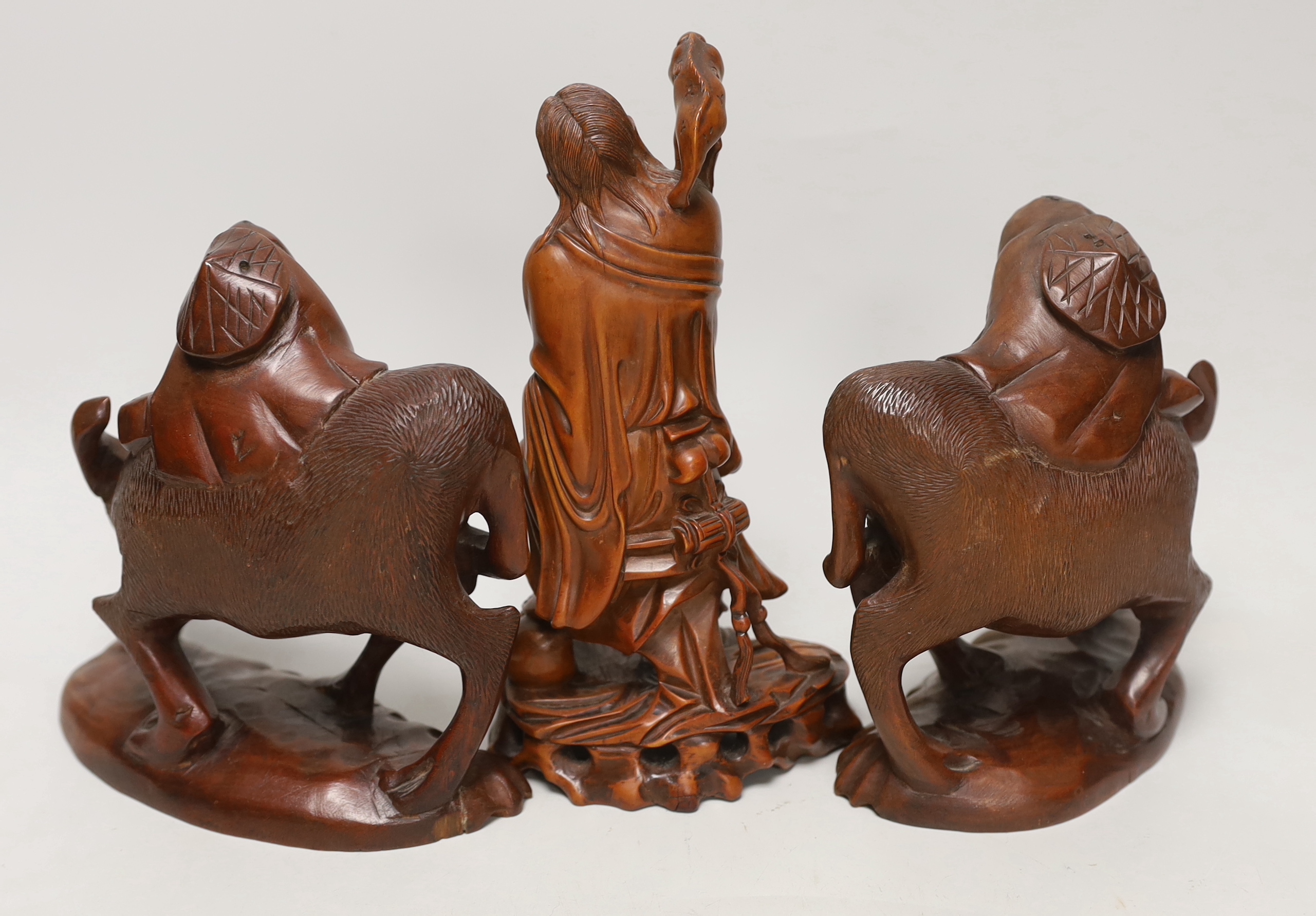 Three Chinese carved hardwood figures, tallest 23cm